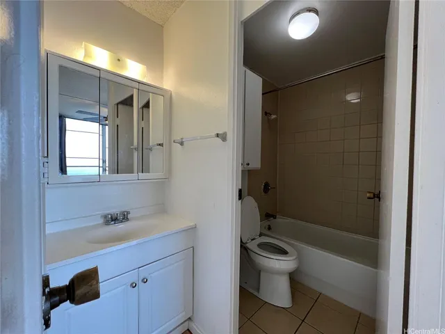 a bathroom with a toilet a sink and shower
