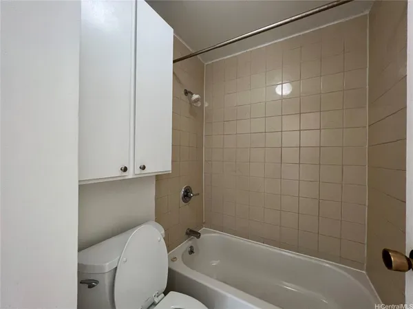 a bathroom with a toilet and shower