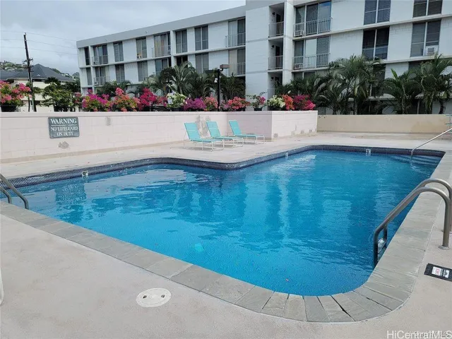 a view of swimming pool with outdoor seating