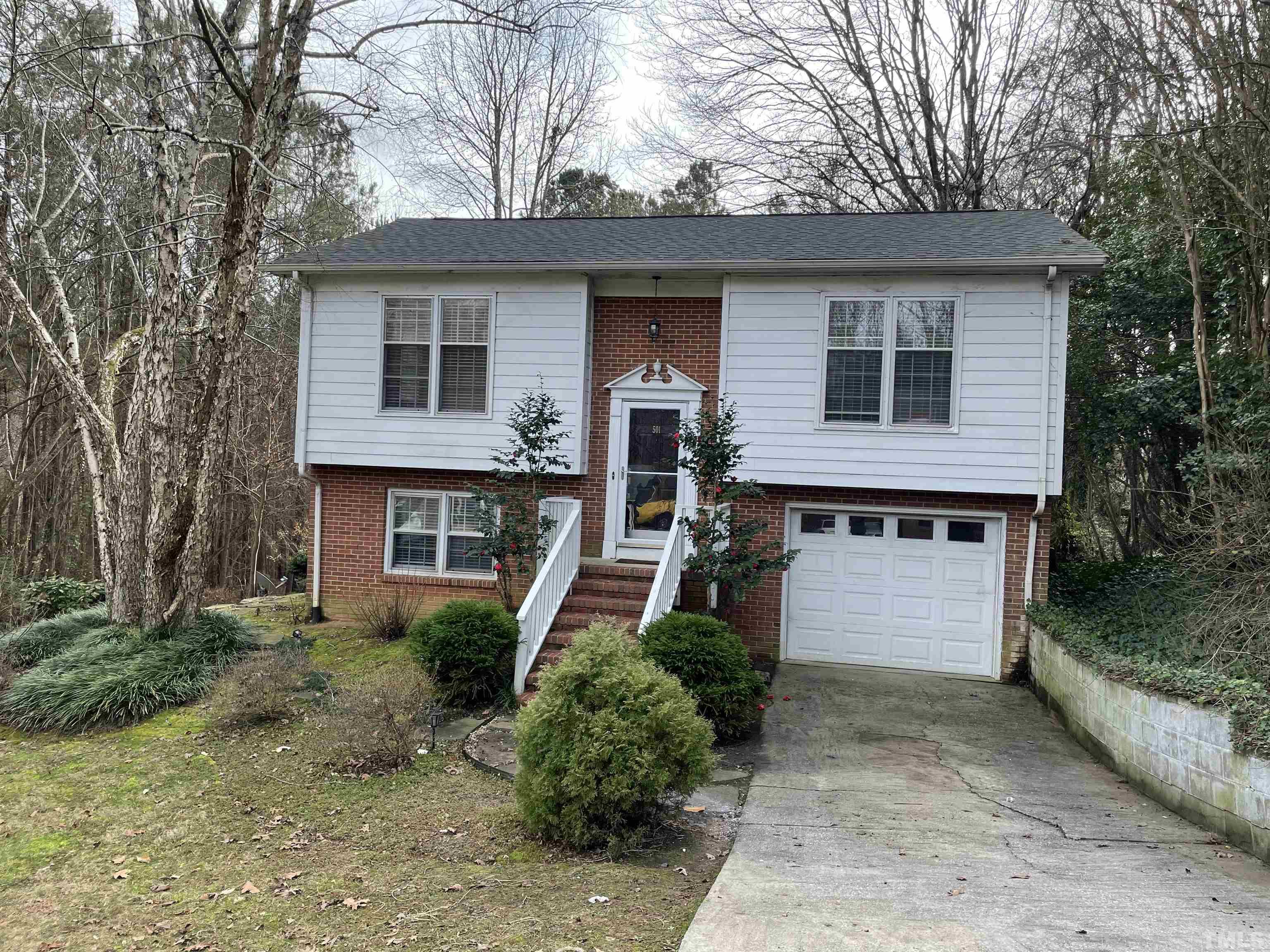 501 Sawmill Road Raleigh, NC 27615 - Photo 1 of 31 a front view of a house with garden