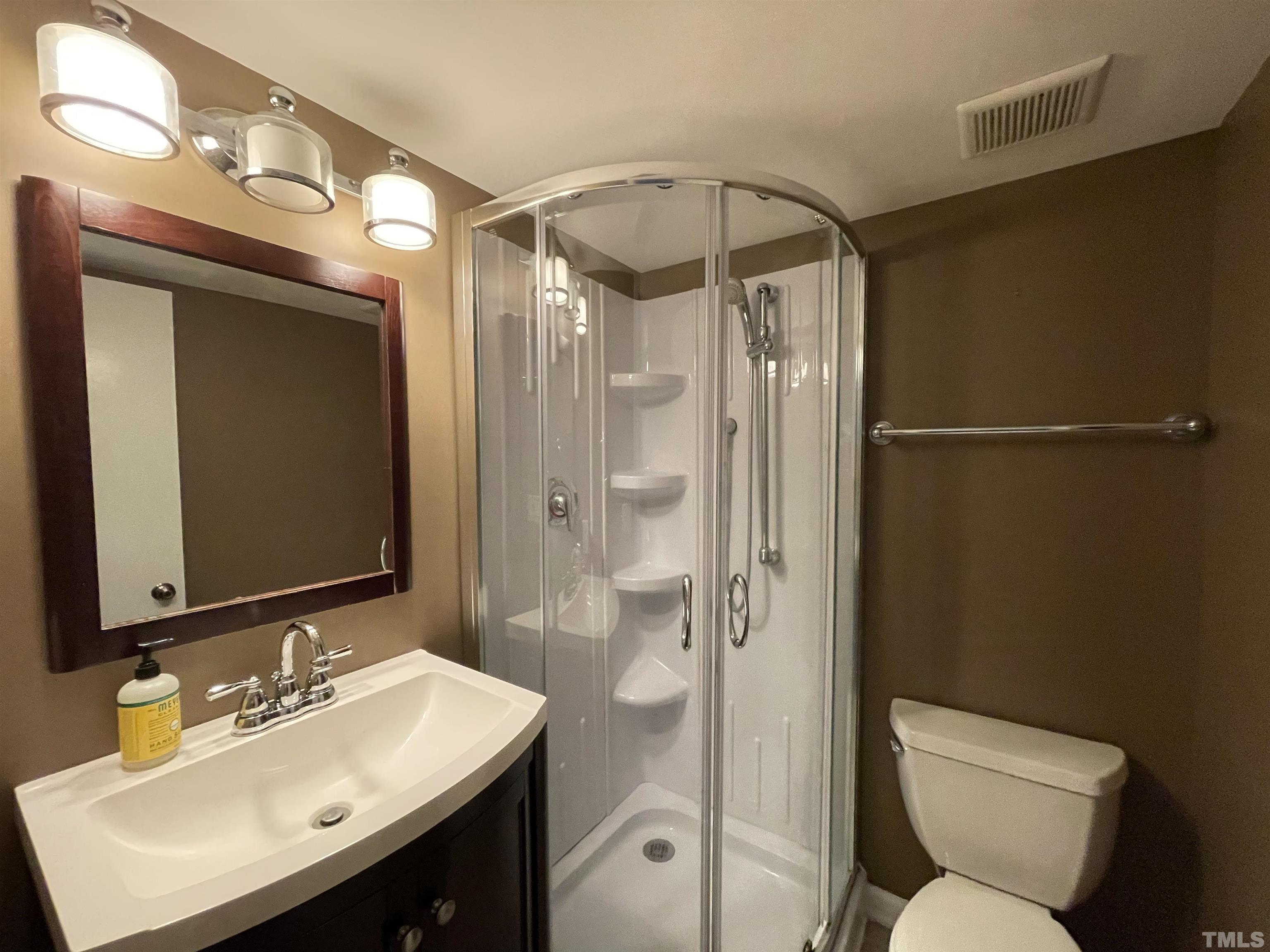501 Sawmill Road Raleigh, NC 27615 - Photo 14 of 31 a bathroom with a sink mirror toilet and shower
