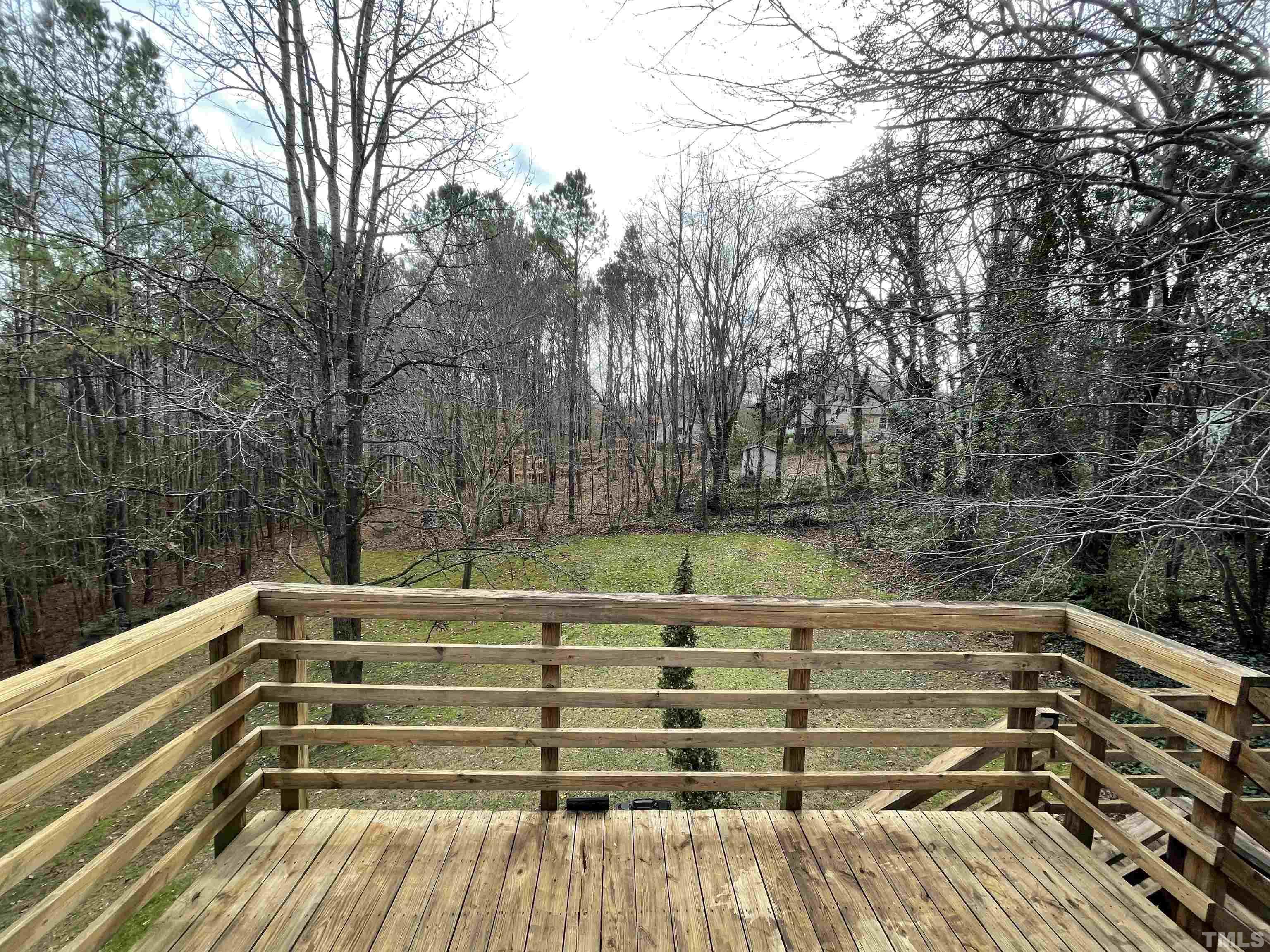 501 Sawmill Road Raleigh, NC 27615 - Photo 3 of 31 a view of a yard with lake and trees in the back