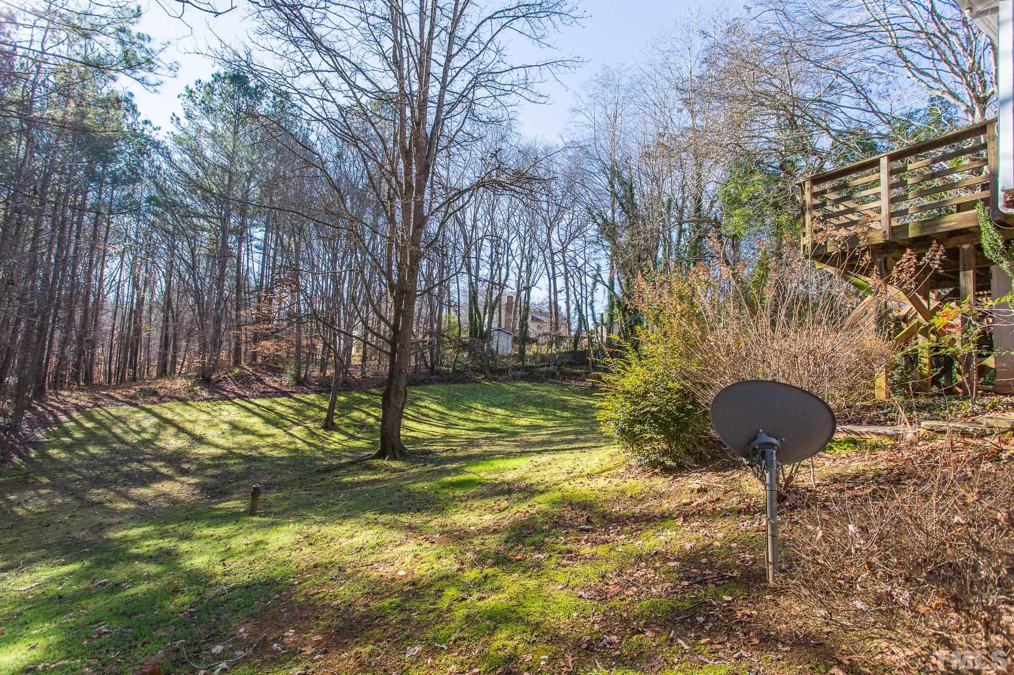 501 Sawmill Road Raleigh, NC 27615 - Photo 29 of 31 a view of a yard with plants and a bench