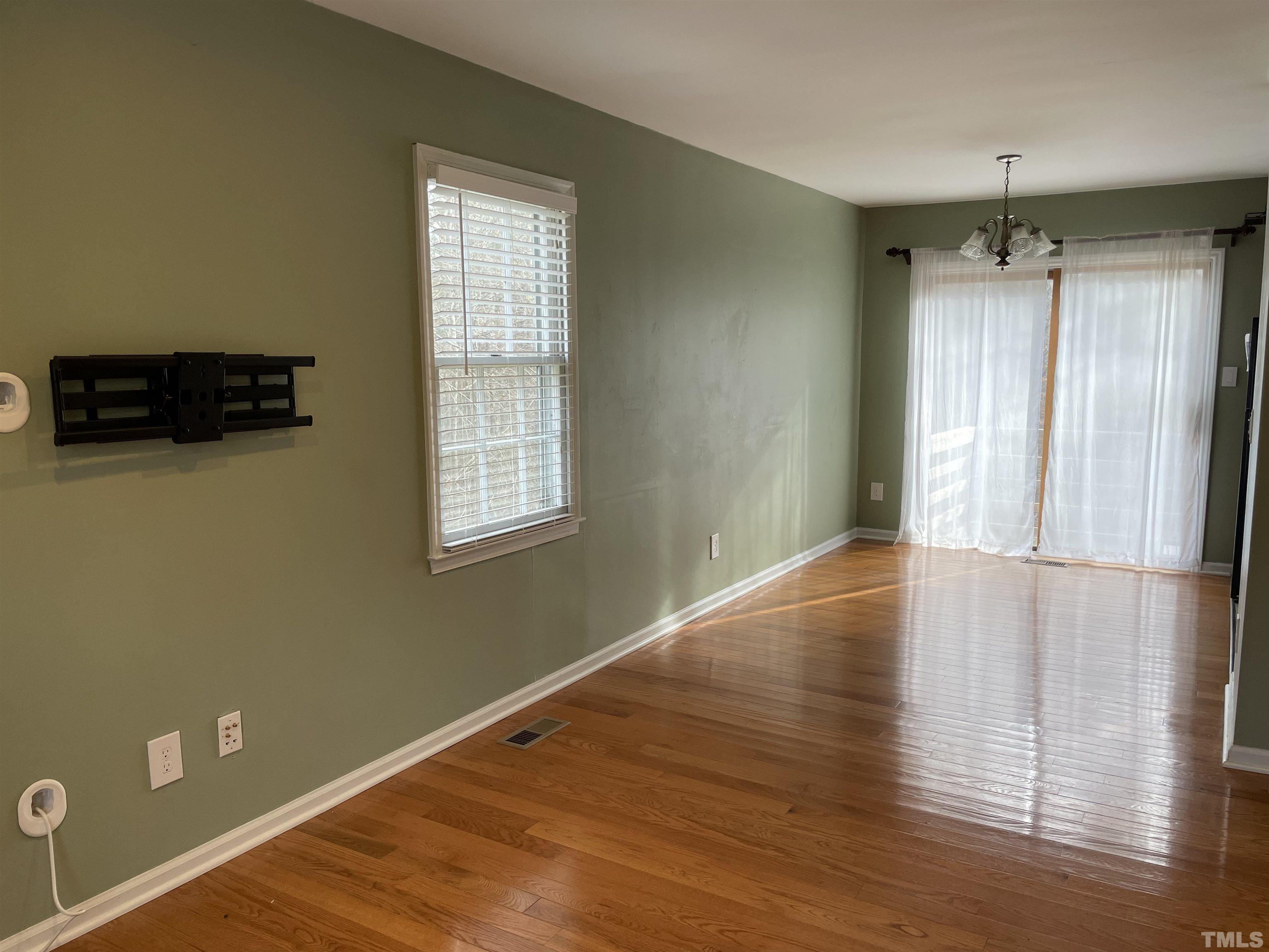 501 Sawmill Road Raleigh, NC 27615 - Photo 4 of 31 a view of an empty room with wooden floor and a window