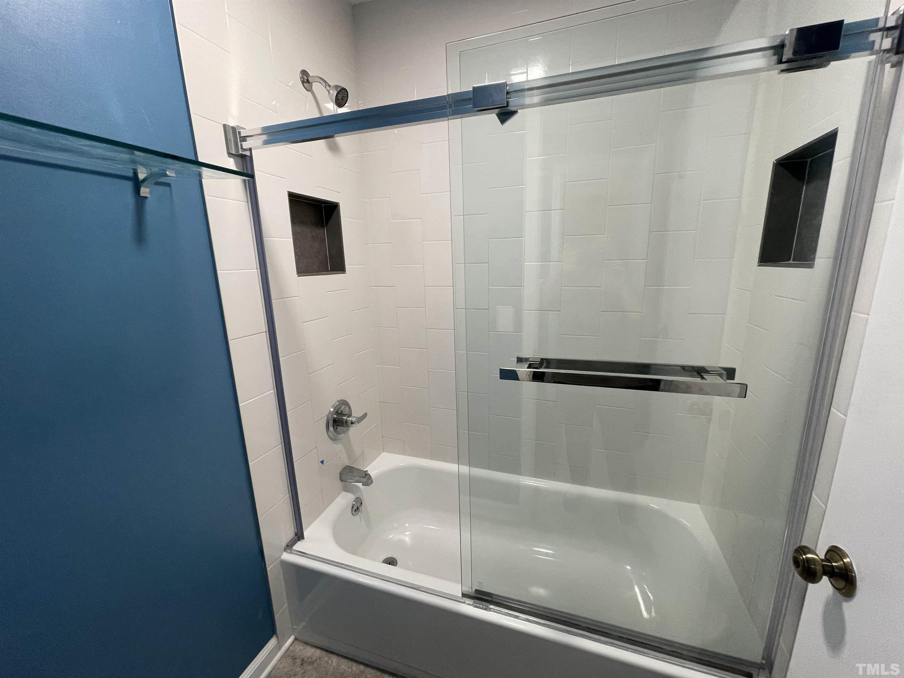 501 Sawmill Road Raleigh, NC 27615 - Photo 10 of 31 a bathroom with a tub a mirror and a shower