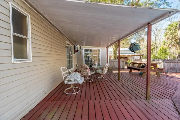 a view of a patio with table and chairs and wooden floor