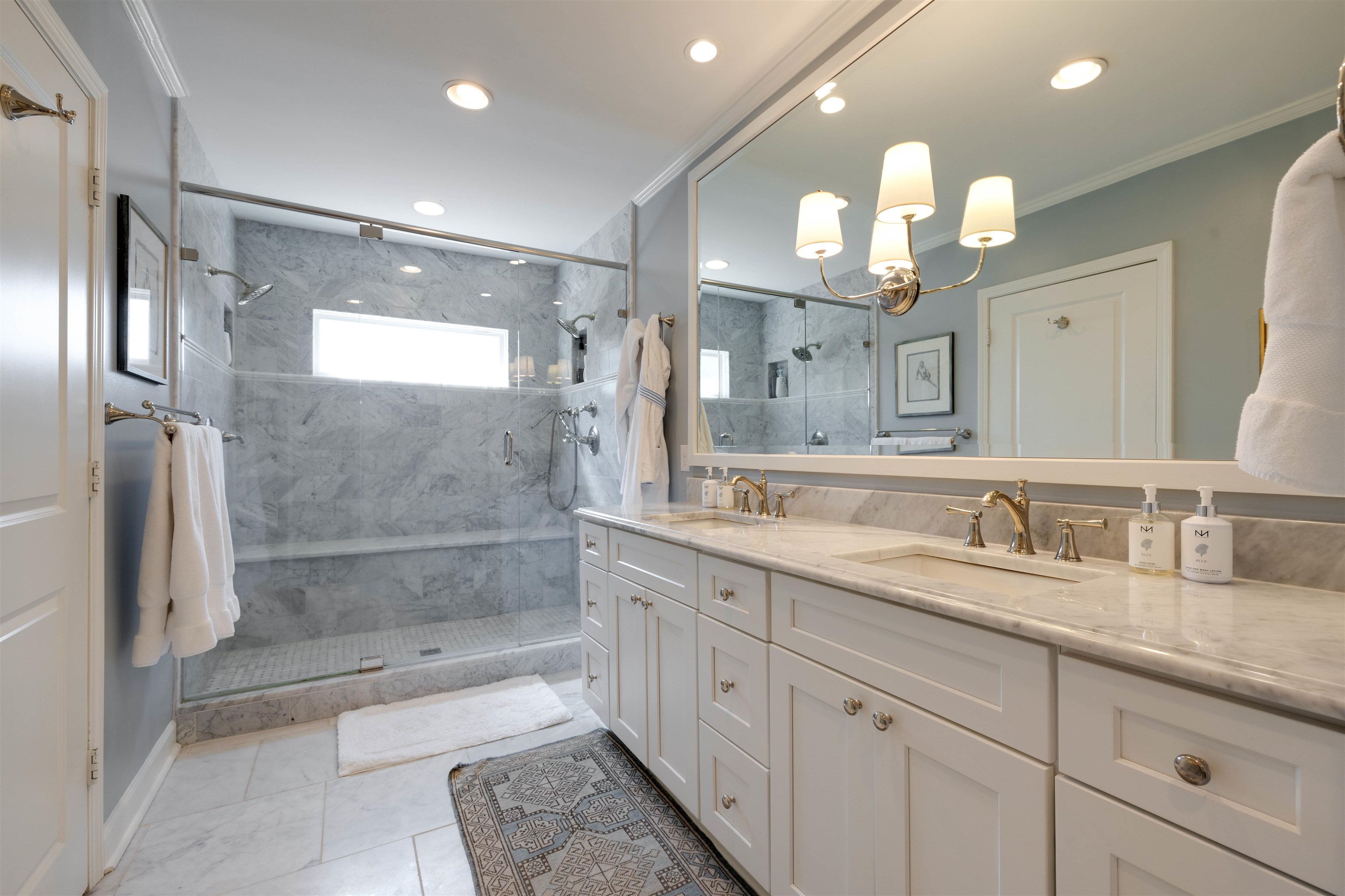 5430 Normandy Road Memphis, TN 38120 - Photo 18 of 32 Just dreamy with double sinks, carrara marble countertops, beveled mirror, Brizo polished nickel fixtures, polished nickel sconce, recessed lighting. Water closet behind the door to the left.
