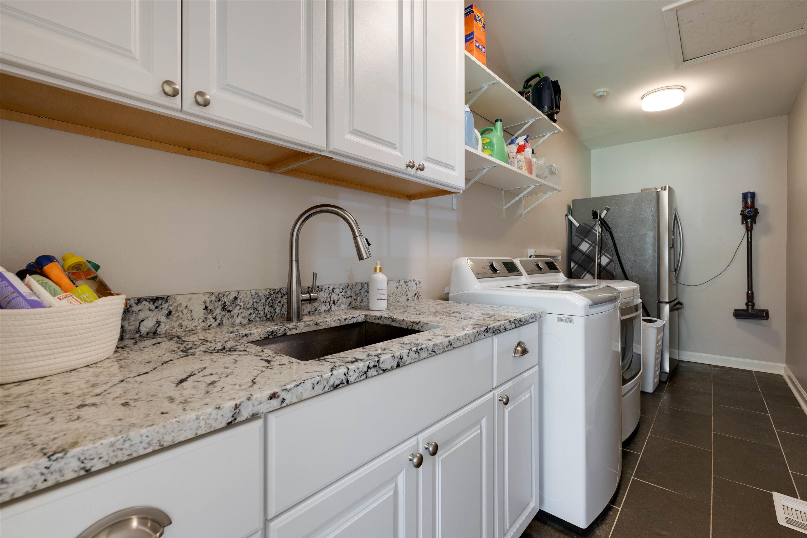 5430 Normandy Road Memphis, TN 38120 - Photo 26 of 32 Even the laundry room has been updated with new cabinetry, polished nickel hardware, granite countertops; the washer, dryer and refrigerator remain.