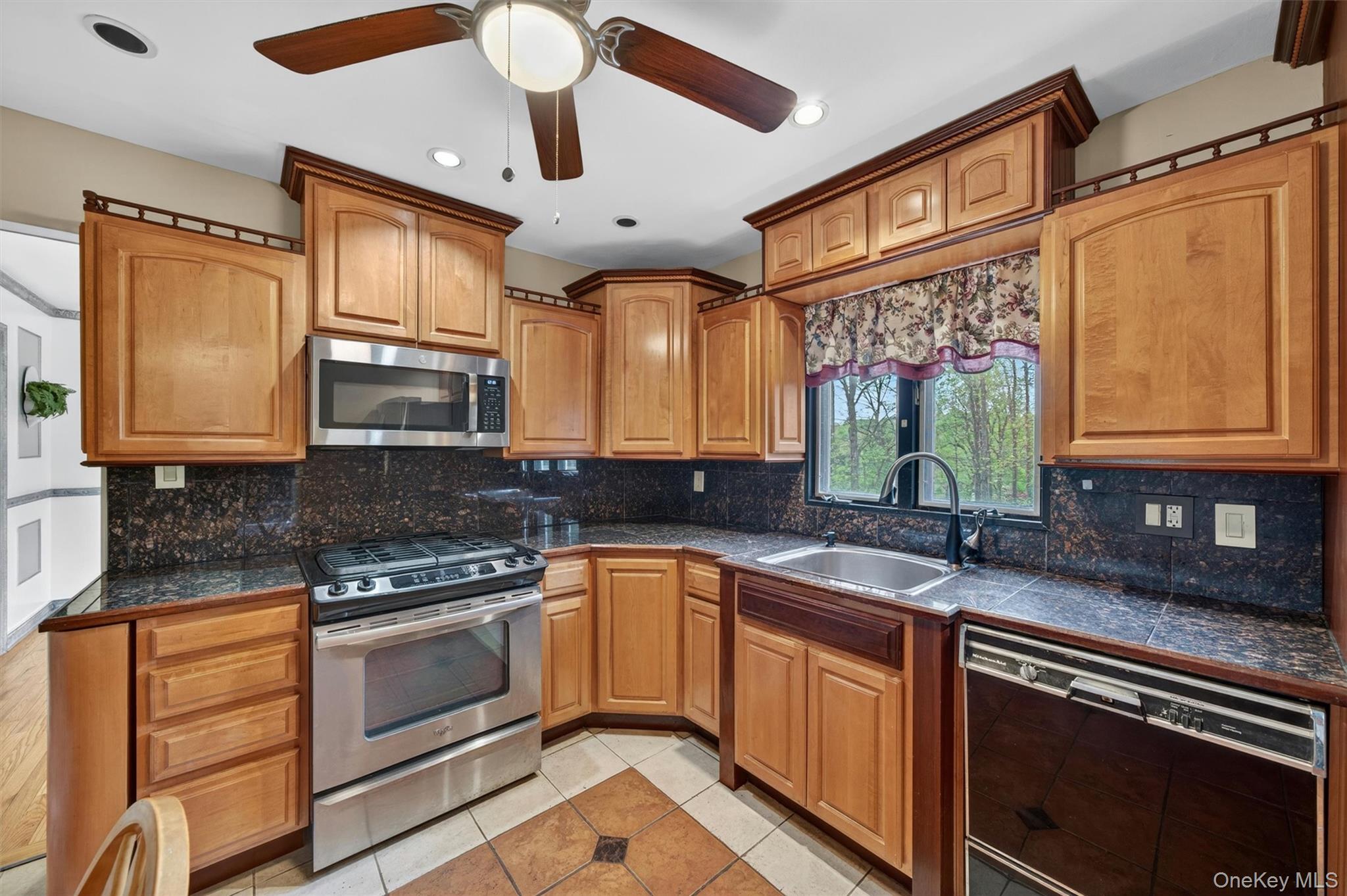 155 Pine Tree Road Monroe, NY 10950 - Photo 14 of 49 a kitchen with stainless steel appliances granite countertop a sink a stove cabinets counter space and a window