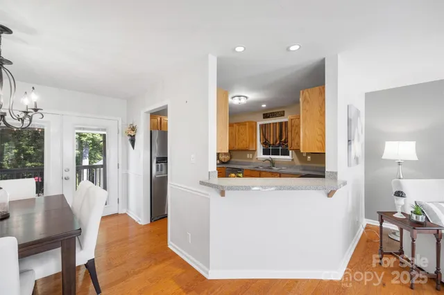 a view of kitchen with kitchen island and stainless steel appliances