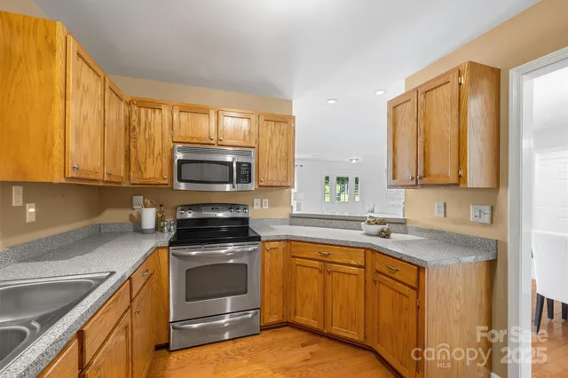 a kitchen with a sink stove and microwave