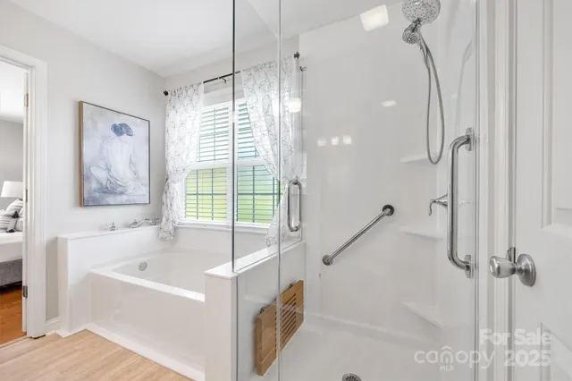 a white bath tub sitting next to a shower