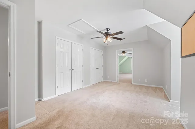 a view of an empty room with a ceiling fan