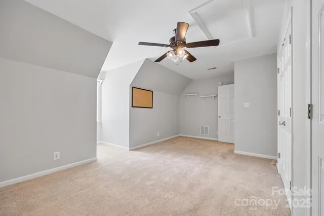 a view of a big room with a ceiling fan