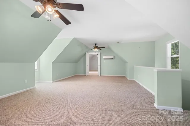 a view of a room with a ceiling fan and window