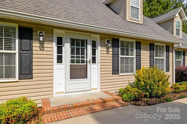 a view of a house with potted plants