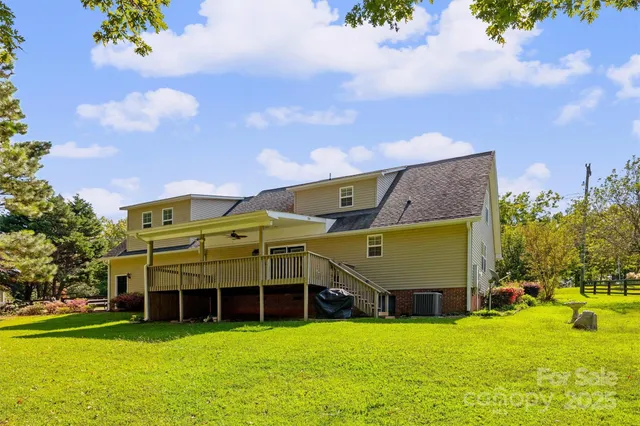 a view of a house with a swimming pool and a yard