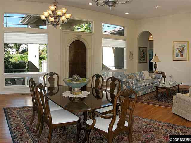 12680 Silver Wolf Road Reno, NV 89511 - Photo 4 of 9 a view of a dining room with furniture a chandelier and large windows