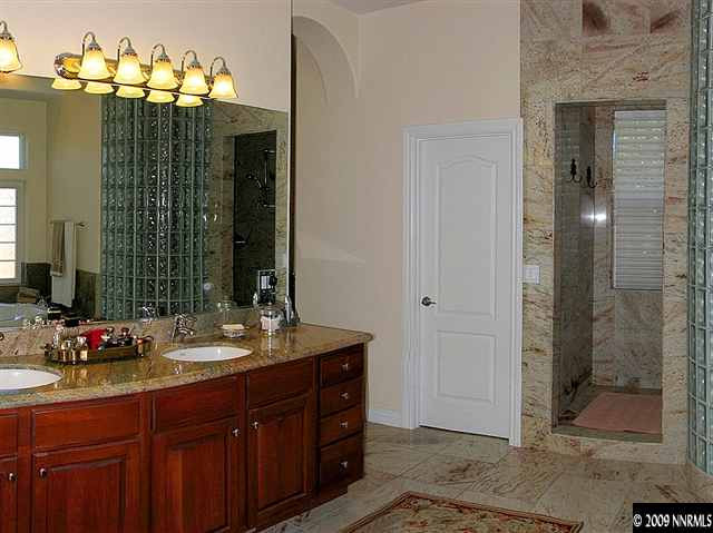 12680 Silver Wolf Road Reno, NV 89511 - Photo 8 of 9 a bathroom with a double vanity sink mirror and shower