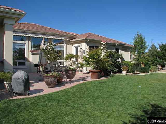 12680 Silver Wolf Road Reno, NV 89511 - Photo 9 of 9 a view of a house with backyard sitting area and garden