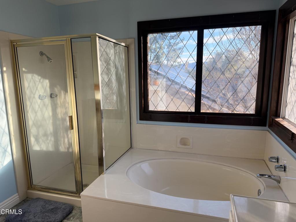 2621 Bitternut Circle Simi Valley, CA 93065 - Photo 16 of 20 a bathroom with a bathtub and a shower