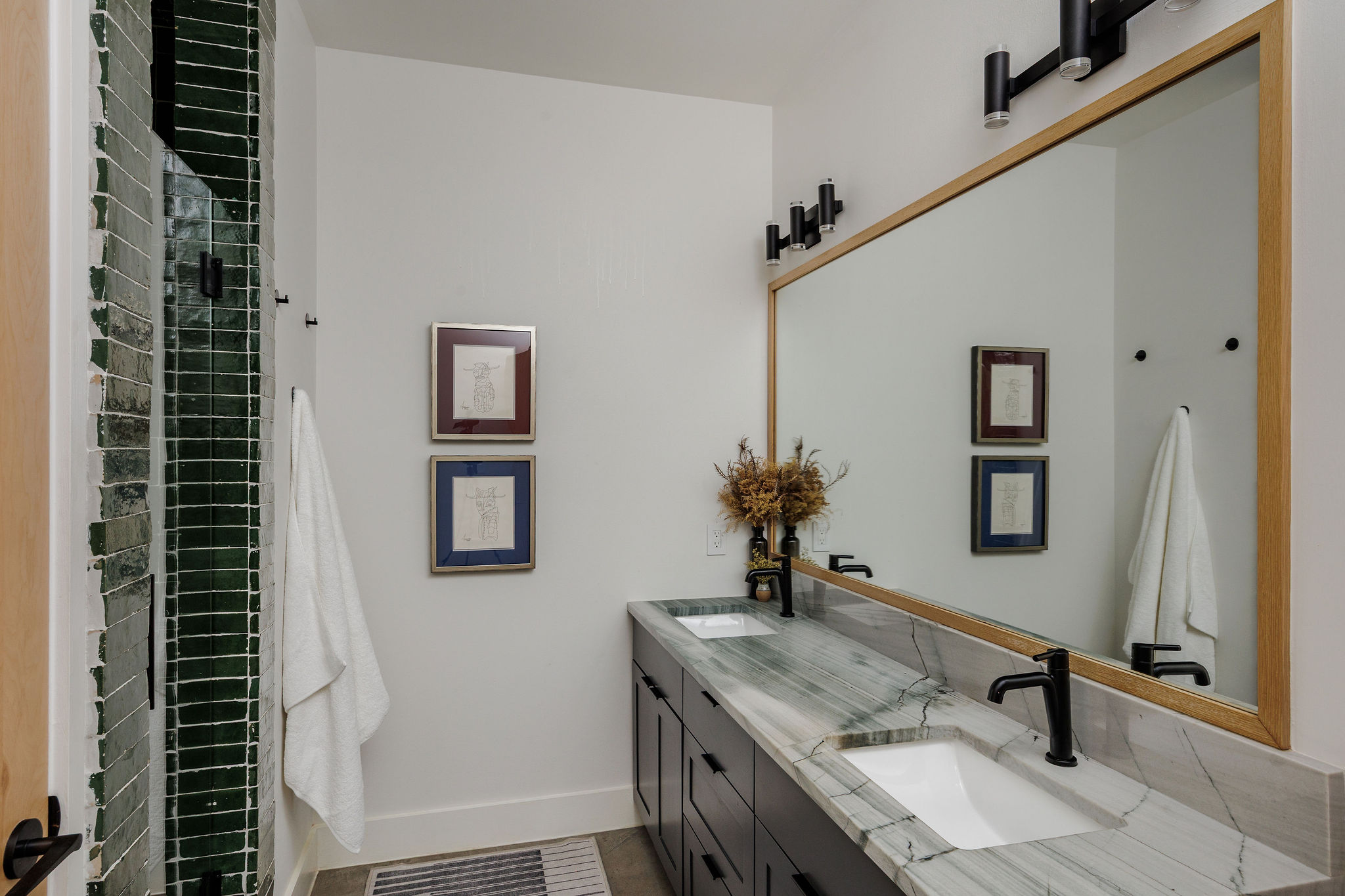1605 Maple Avenue Austin, TX 78702 - Photo 22 of 33 Double vanity with integrated sinks, a patterned countertop, and black fixtures