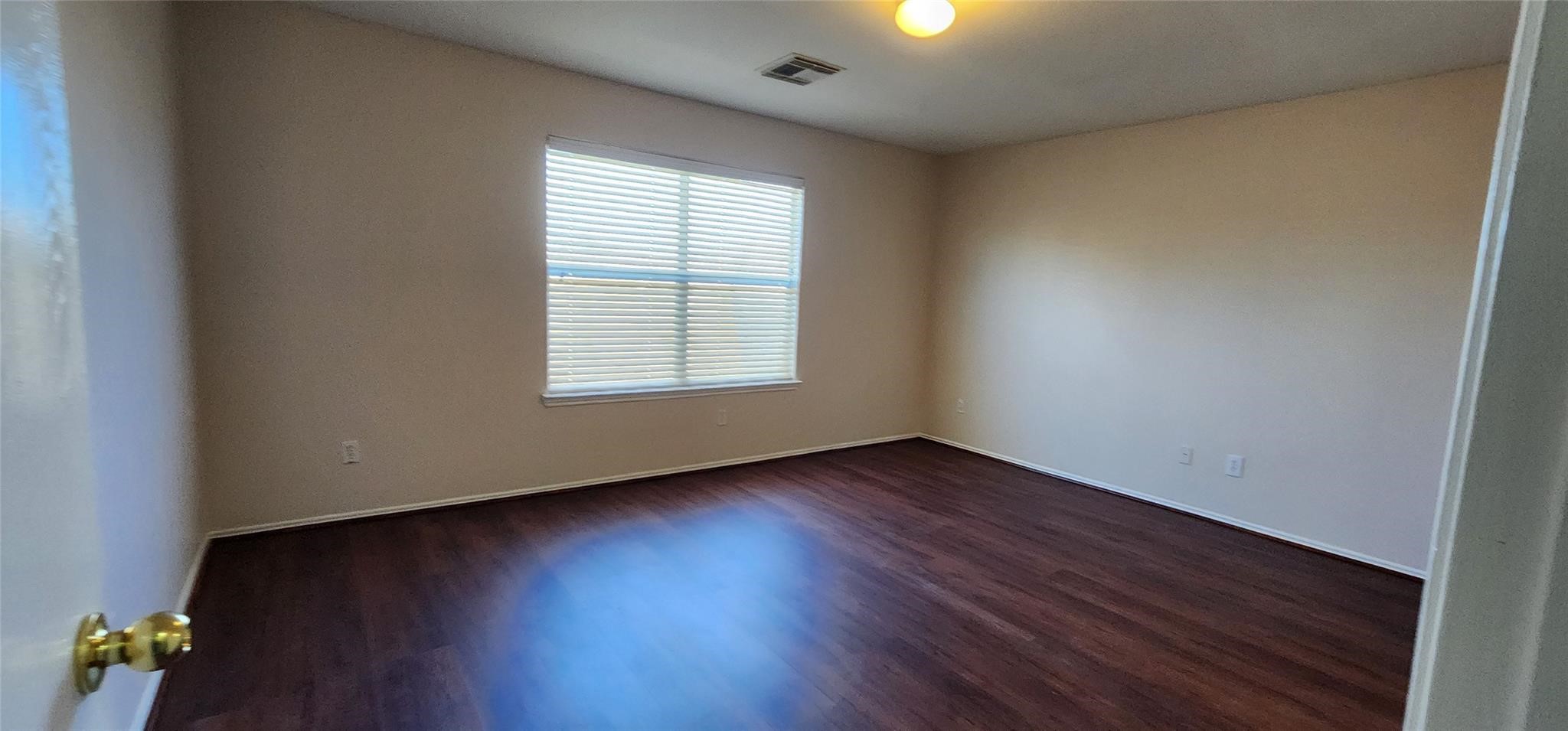 315 Sunset Colony Drive Rosharon, TX 77583 - Photo 12 of 20 an empty room with wooden floor and windows
