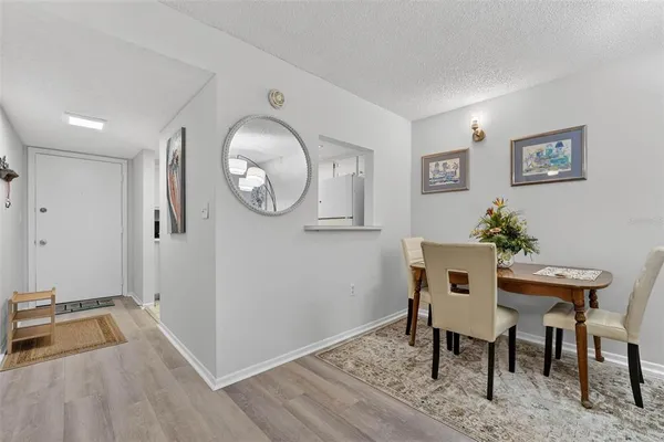 a view of a room that has a table and a chair in it