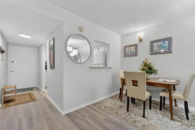 a view of a room that has a table and a chair in it