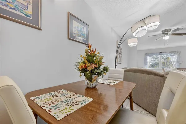 a view of a dining room with furniture and a chandelier