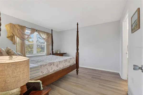 a spacious bedroom with a bed and a large window