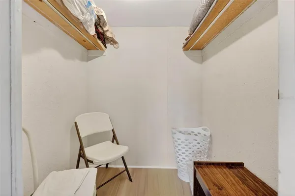 a view of a chair and wooden floor in a room