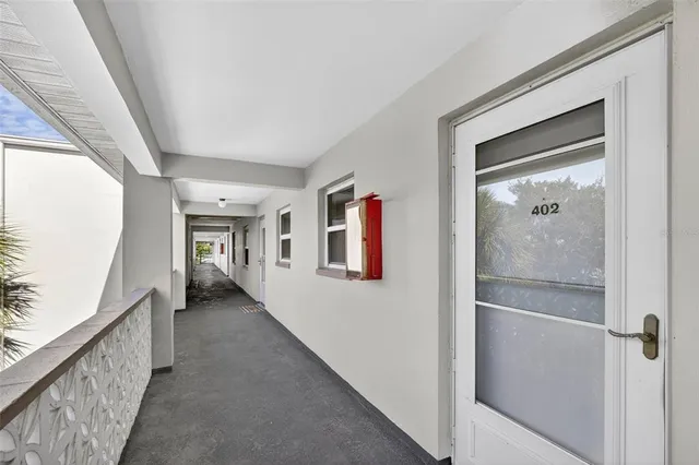 a hallway with wooden floor chandelier and hallway