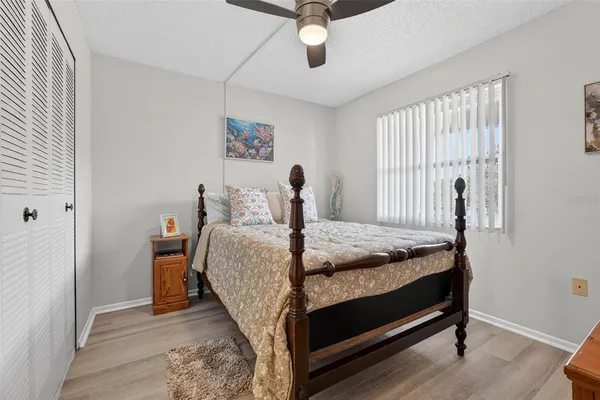 a bedroom with a bed and large windows