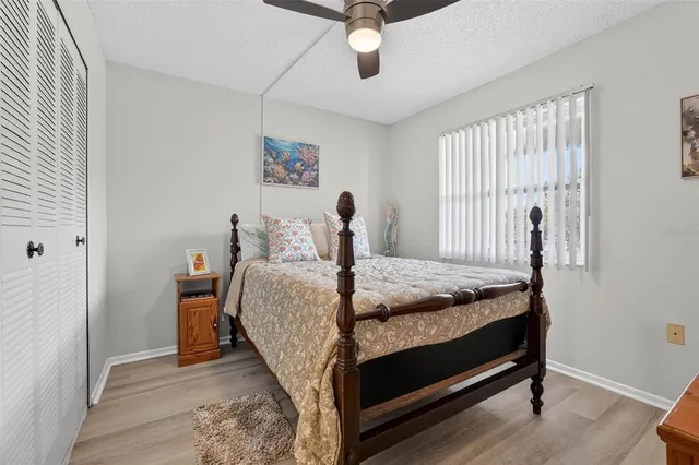 a bedroom with a bed and large windows