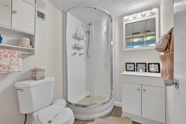 a bathroom with a toilet sink and shower