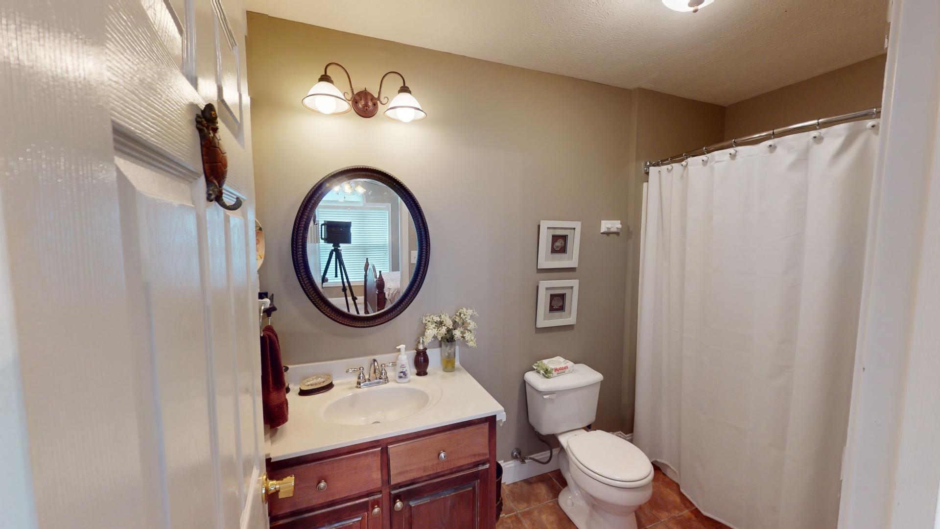 19 Aqua Drive Iuka, MS 38852 - Photo 25 of 33 a bathroom with a sink a toilet and a mirror