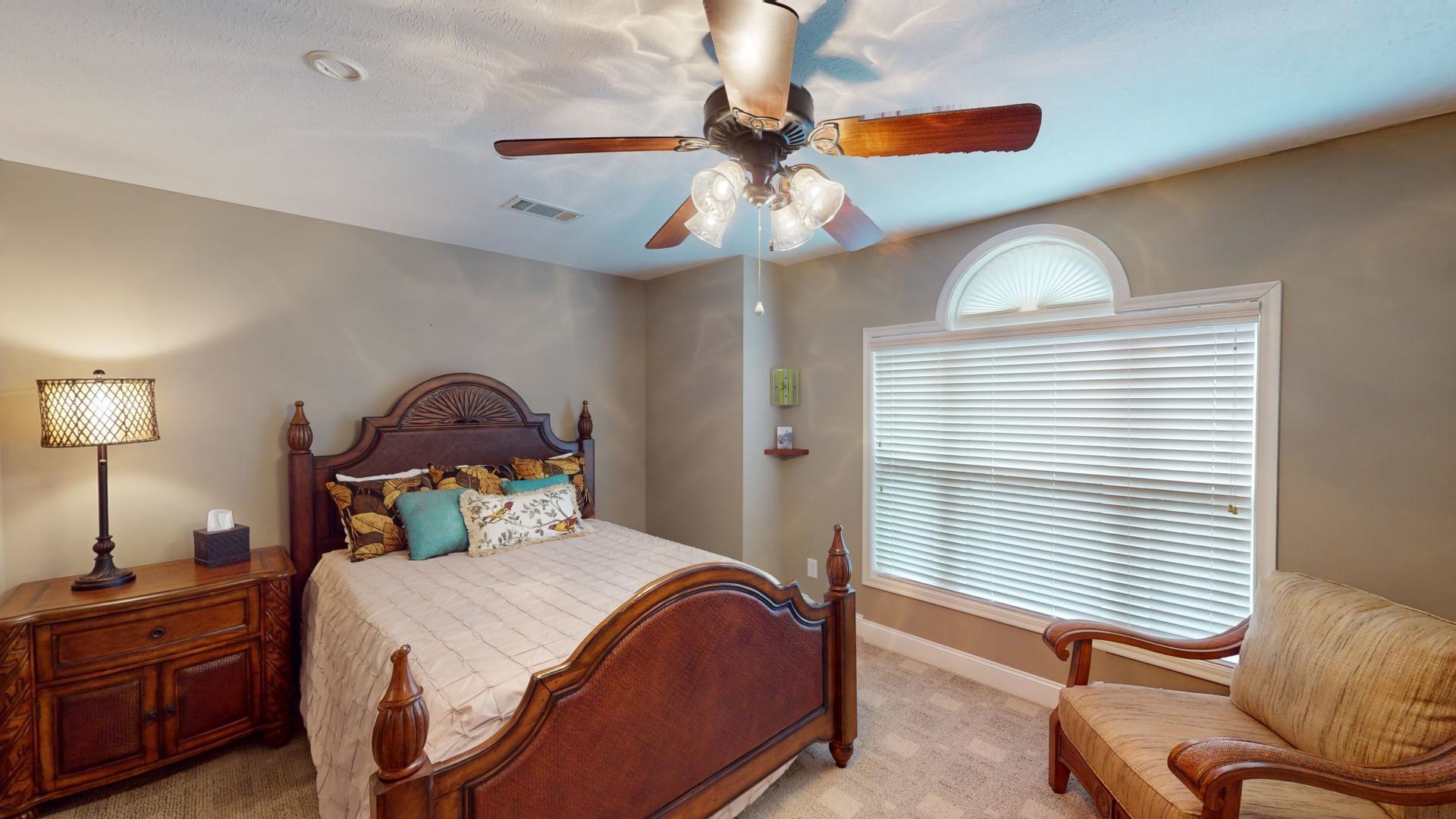 19 Aqua Drive Iuka, MS 38852 - Photo 29 of 33 a bedroom with a bed and a chandelier