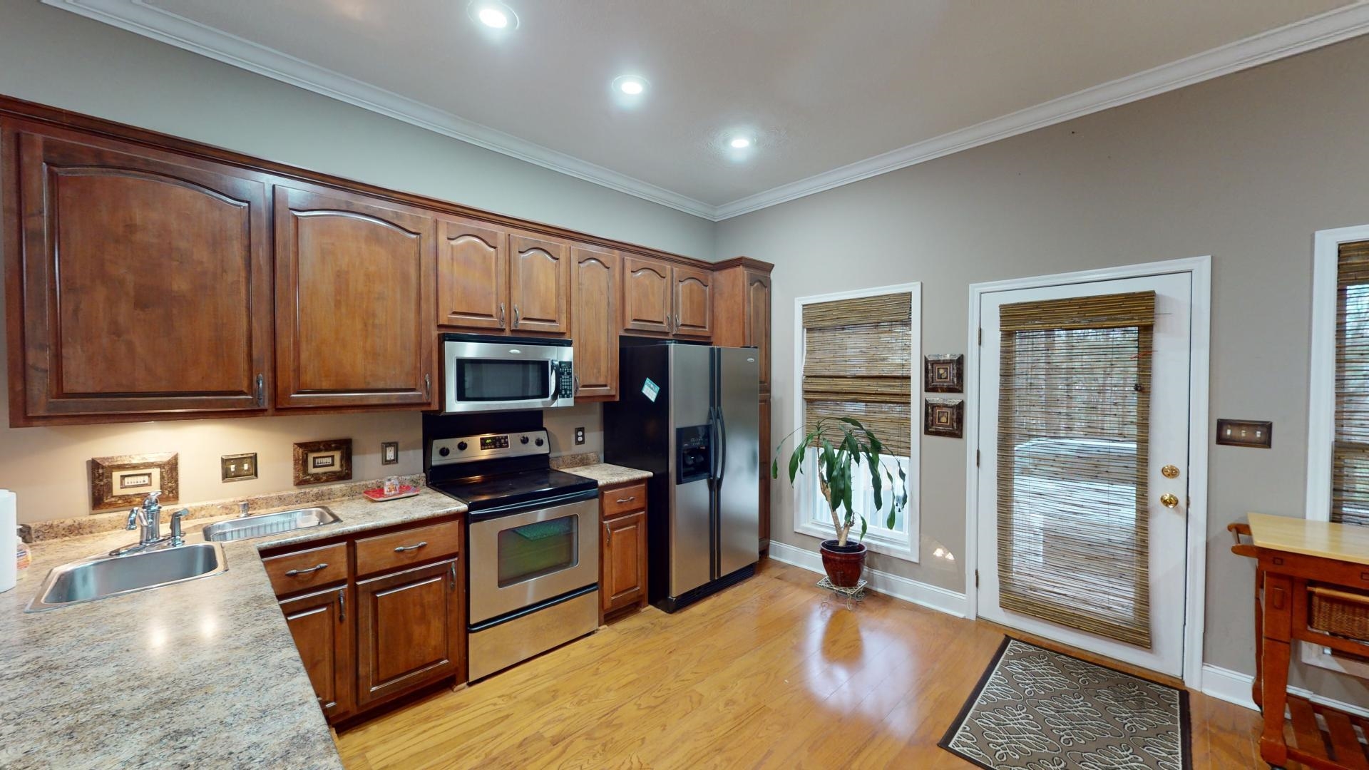 19 Aqua Drive Iuka, MS 38852 - Photo 5 of 33 a kitchen with stainless steel appliances granite countertop a refrigerator stove and sink