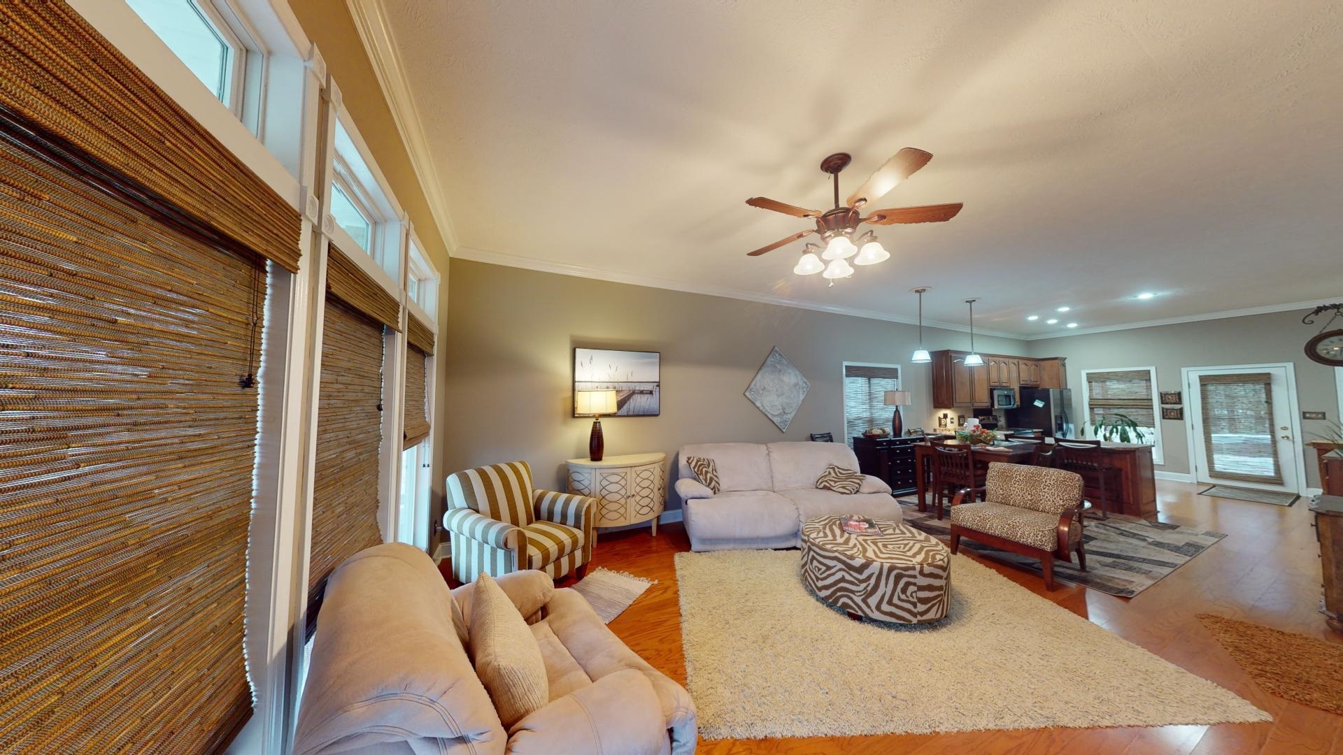 19 Aqua Drive Iuka, MS 38852 - Photo 9 of 33 a living room with furniture a fireplace and a chandelier