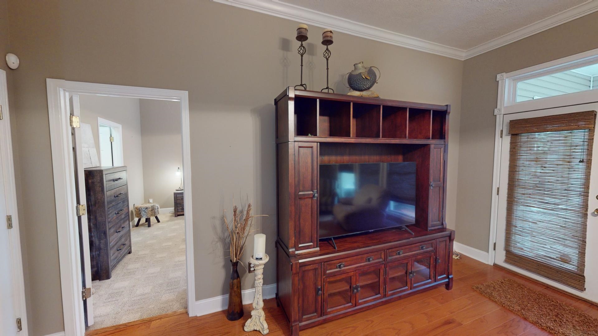19 Aqua Drive Iuka, MS 38852 - Photo 10 of 33 a living room with furniture a flat screen tv and a fireplace
