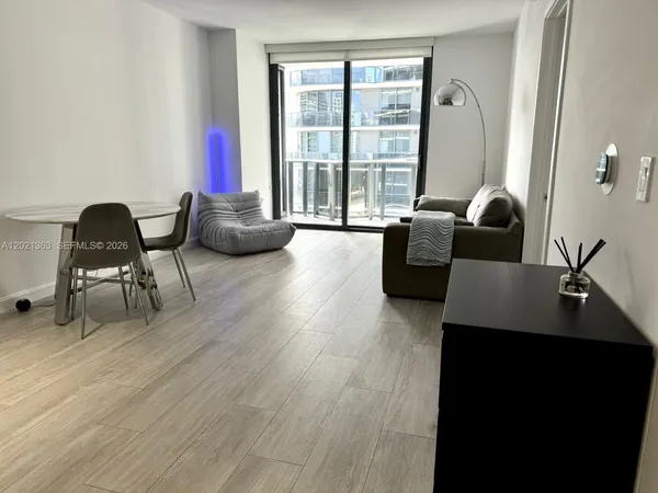 a living room with furniture and a large window