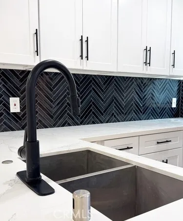 a large kitchen with a large counter top appliances and cabinets