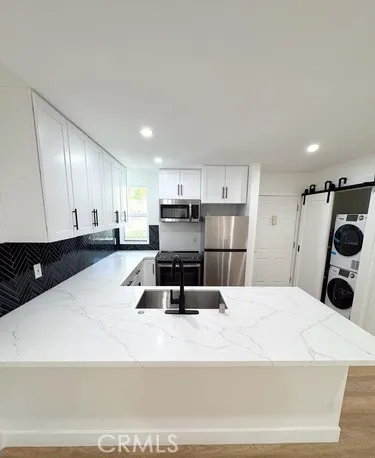 a bathroom with a tub sink mirror and toilet