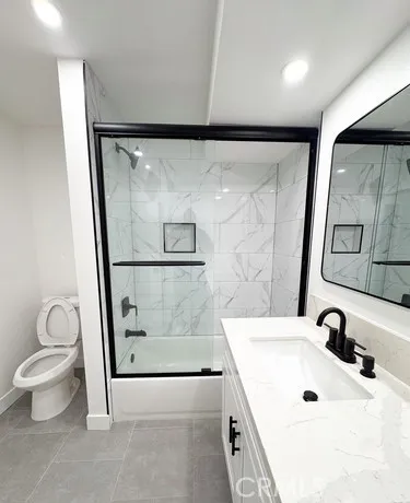 a bathroom with a sink vanity and mirror