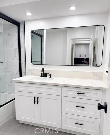 a bathroom with a double vanity sink and mirror