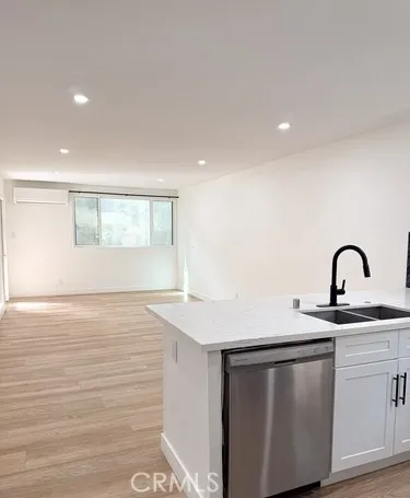 a view of a kitchen with sink and wooden floor