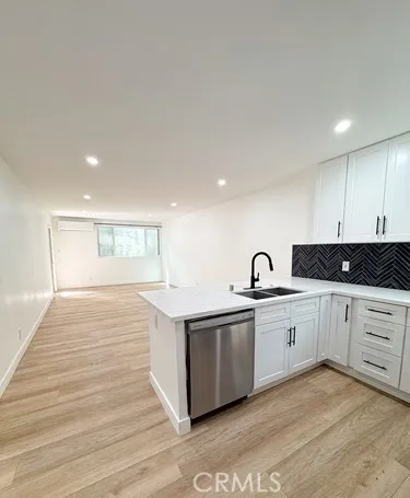 a kitchen with a sink and cabinets