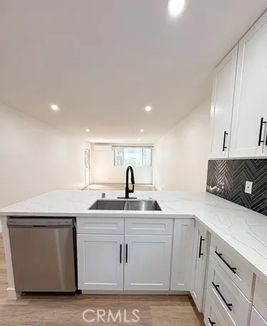 a view of kitchen with kitchen island microwave and cabinets