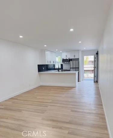 a view of kitchen and kitchen with stainless steel appliances